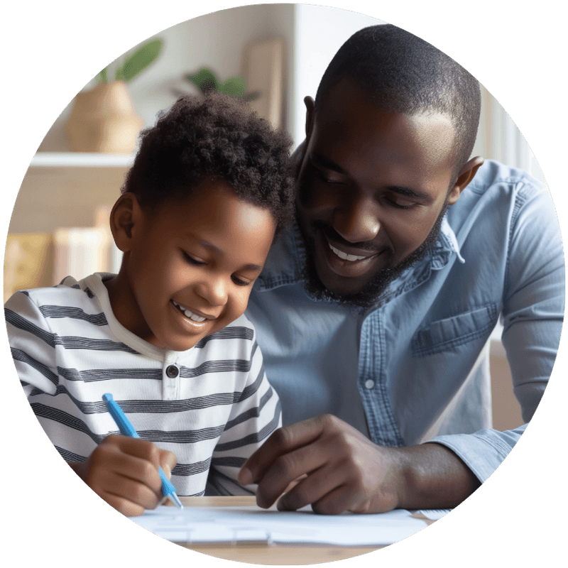 A father helping his young son with homework, both smiling