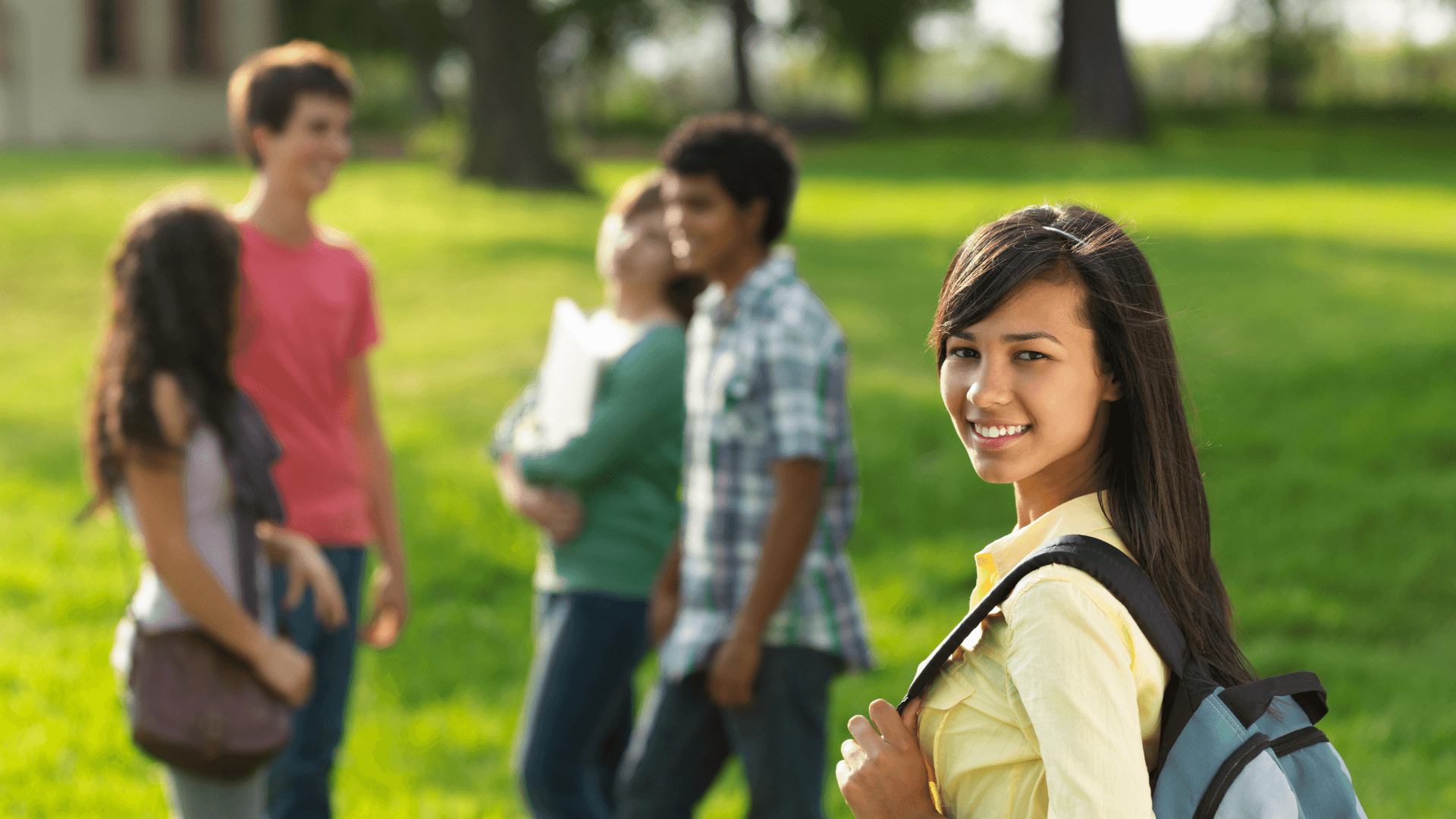 A small group of teens talking together outdoors